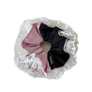 Elegant lace scrunchie with pink and black polka dot fabric for women hair styling