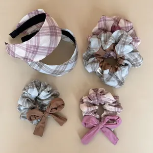 Detailed top view of Korean style plaid headbands and bow scrunchies in earth tones