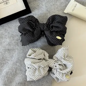 Detail of Korean style polka dot bow banana hair clips for vintage ponytail hair styling