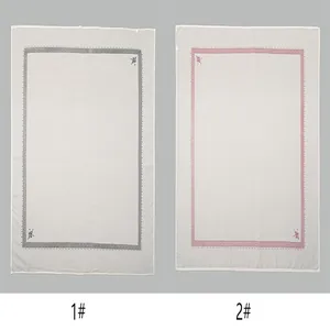 Comparison of two printed men's square headscarves with grey and pink borders shown side by side