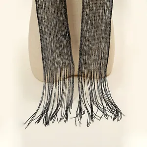 Close-up of black metallic skinny scarf with fringe detail on a mannequin.