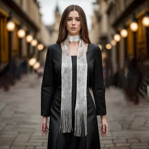Elegant silver metallic fringe neck scarf shown on a fashion model in a street setting.