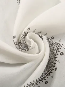 Macro detail of ethnic print square scarf showing the soft cotton fabric texture