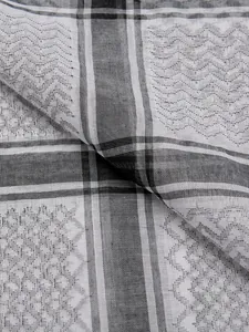 Close-up of a black and white checkered jacquard scarf showing fine fabric texture