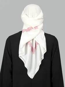 Detailed view of white men's ethnic headscarf with red floral printed borders