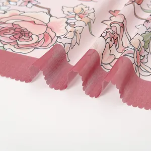 Detailed macro view of floral print square hijab with elegant laser-cut wavy edges.