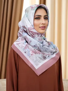 Detailed view of an elegant floral printed square hijab with laser-cut scalloped edges