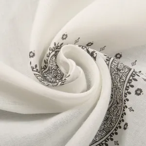 Close-up of white men's ethnic print bandana with intricate black paisley patterns