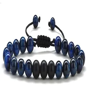 Close-up of men's blue tiger eye and matte black beaded braided bracelet