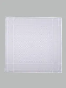 Close-up showing the intricate jacquard checkered pattern on a white square headscarf