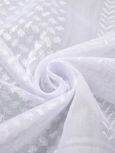 Close-up of elegant white jacquard checkered fabric showing intricate woven texture