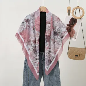 Mauve floral print square scarf with laser-cut edges displayed with lifestyle props