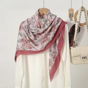 Detail view of pink floral print hijab with laser-cut edges and elegant patterns