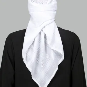 White jacquard checkered headscarf wrapped style on a model with black clothing backdrop