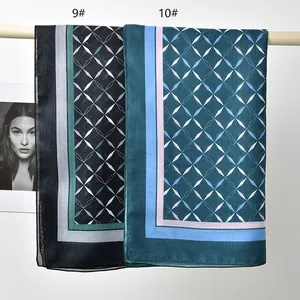Detail view of two printed polyester square scarves with geometric patterns in black and teal