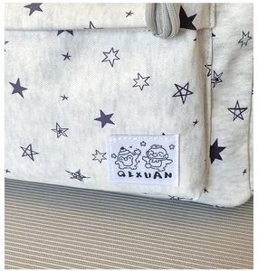 Close-up of star pattern fabric and brand logo patch on the stylish school backpack