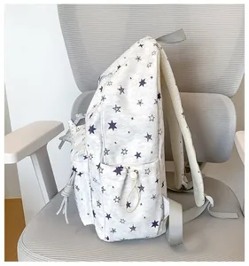 Side view detail of a grey backpack with purple star prints for students