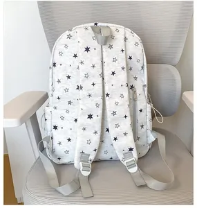 Detailed back view of the gray star-print school backpack with adjustable straps