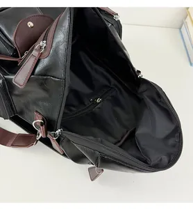Close-up showing internal lining and zipper pocket of black vintage motorcycle bag
