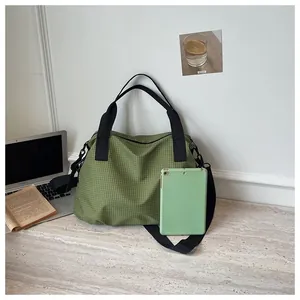 Large capacity green checkered nylon tote bag shown with tablet for size reference