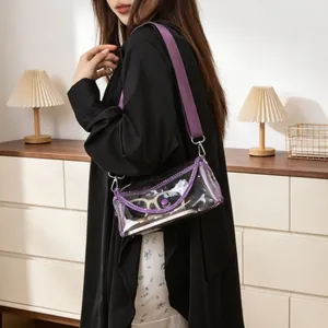 Lifestyle shot of a woman wearing a transparent PVC crossbody bag with purple trim