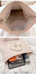 Interior detail of pink lightweight travel backpack showing storage capacity for laptop and phone