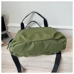Close-up of green grid nylon tote bag showing durable texture and large capacity