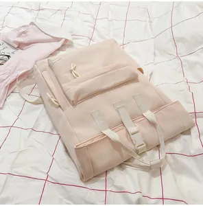 Detail view of a minimalist light pink lightweight travel backpack on white grid sheet
