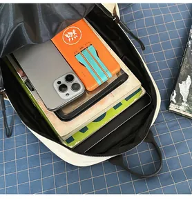 Interior view of minimalist backpack showing spacious compartment for laptop and phone