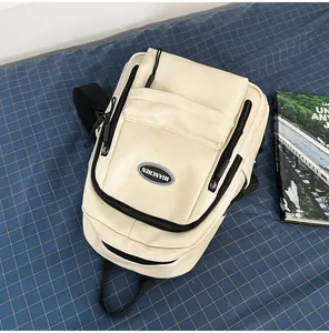 Close-up view of a minimalist beige PU leather backpack featuring multi-zipper design