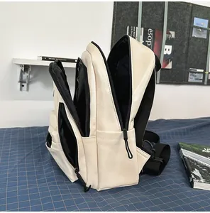 Side view of cream minimalist backpack showing multiple interior compartments