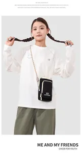 Close-up of a black crossbody phone bag with colorful rope strap on an Asian model