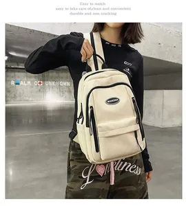 Beige minimalist nylon backpack for students and travel shown with a casual street model