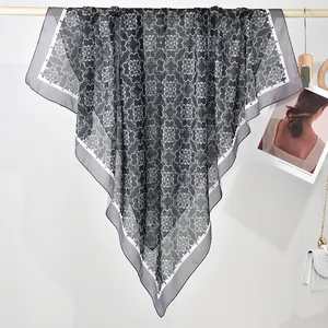 Detailed view of grey printed polyester square scarf with intricate white mandala patterns