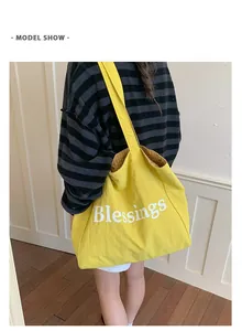 Detailed view of the yellow Blessings tote bag with checkered interior lining