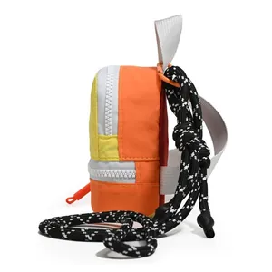 Side detail view of colorful dopamine style small storage bag with black and white rope strap