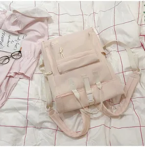 Detailed view of lightweight pink nylon backpack on casual lifestyle background.