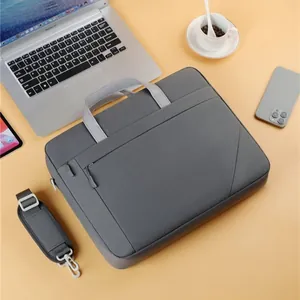 Grey business laptop bag on desk with laptop and smartphone accessories