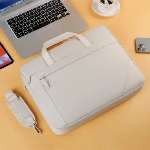 Minimalist business laptop briefcase in light gray, shown in a professional office setting.