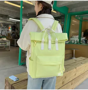 Rear view of woman wearing a lightweight lime green casual outdoor backpack in a cafe setting