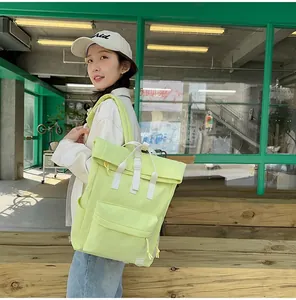 Model wearing a light green lightweight travel backpack in a casual outdoor setting