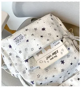 Detailed view showing the star print canvas backpack and its matching pencil case
