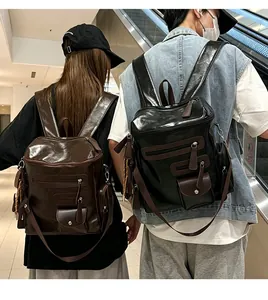 Back view of models wearing retro glossy PU leather motorcycle backpacks in a lifestyle setting