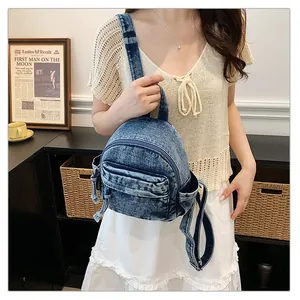 Woman holding a vintage blue denim mini backpack, casual lightweight school bag for students