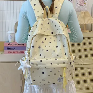 Back view of a student wearing a yellow star print backpack with plush charm