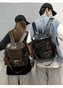 Vintage motorcycle style backpacks in black and brown worn by models for street style