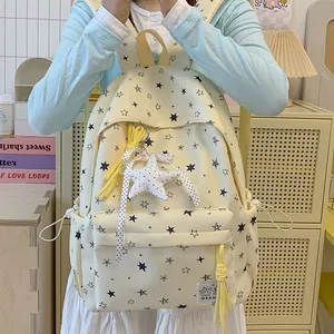 Cream-colored star pattern backpack featuring a cute plush star keychain accessory