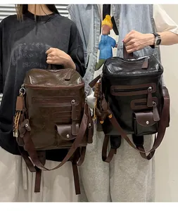 Detail of retro women's motorcycle-style backpacks in brown and black faux leather