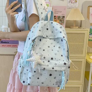 Detailed view of light blue star print backpack featuring cute star pendant accessory