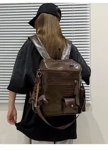 Back view of a large vintage brown faux-leather backpack worn by a model in casual wear.